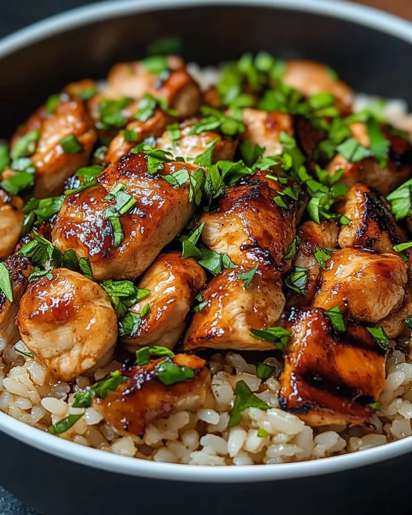 Close-up of Honey Chipotle Chicken and Rice in a bowl with garnished herbs