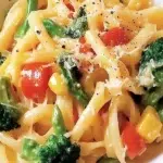 The New Ultimate Pasta Primavera – Fresh & Easy Recipe 6 Fresh pasta primavera with colorful vegetables in a white bowl garnished with basil and Parmesan cheese